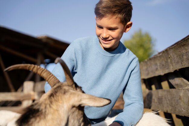 Medium shot smiley kid and goat