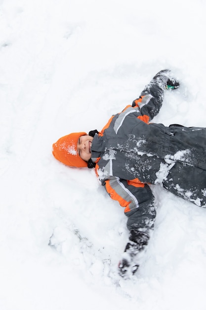 Medium shot smiley kid laying on ground