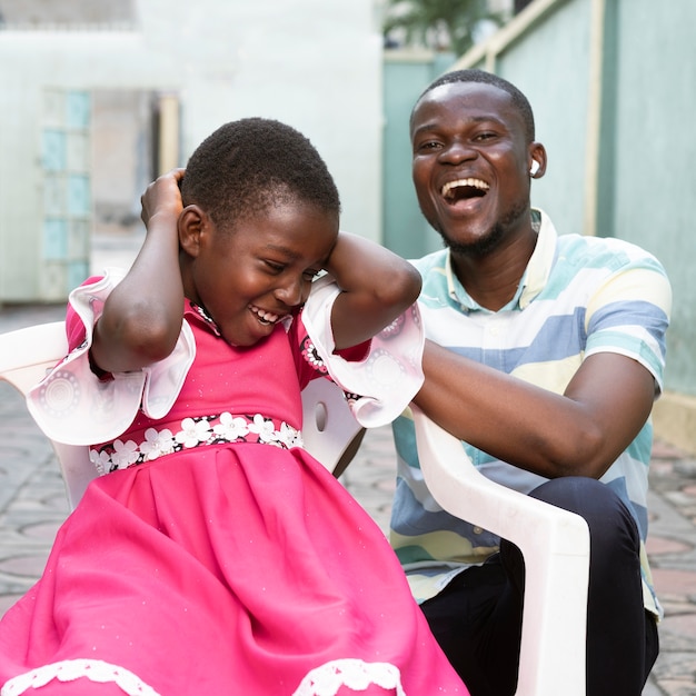 Medium shot smiley kid and man