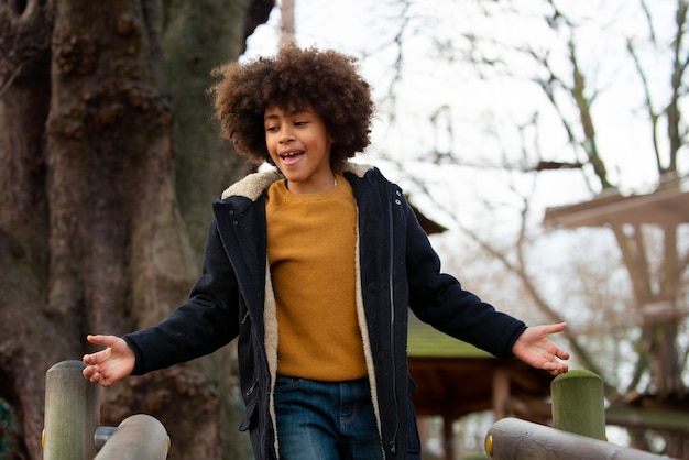 Free photo medium shot smiley kid outdoors