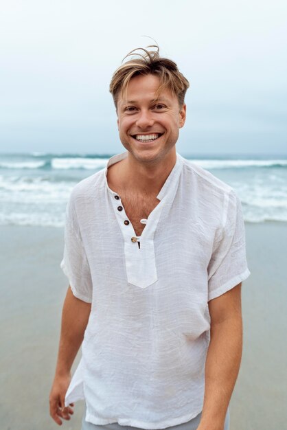 medium shot smiley man at beach