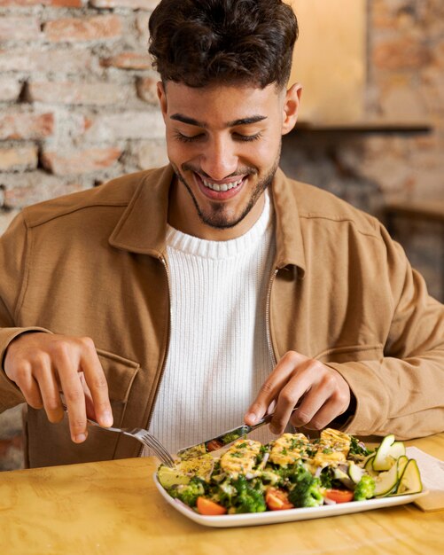 Medium shot smiley man eating food