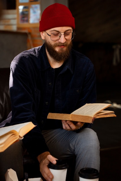 Foto gratuita libro della holding dell'uomo di smiley del colpo medio