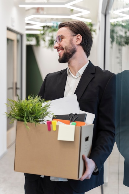 Medium shot smiley man holding box