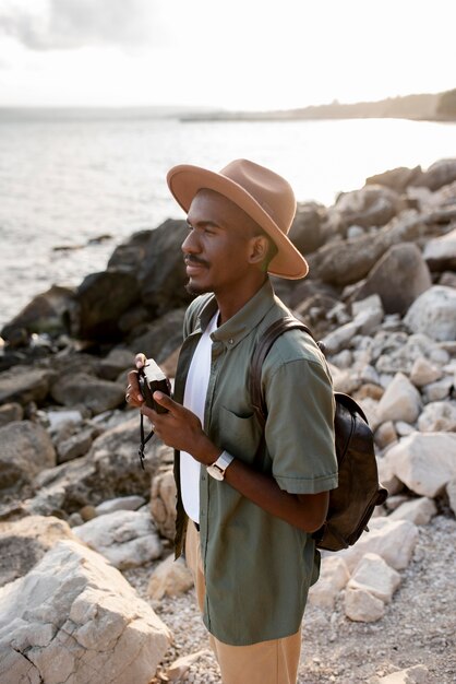 Medium shot smiley man holding camera