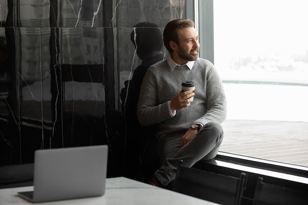 Free photo medium shot smiley man holding cup