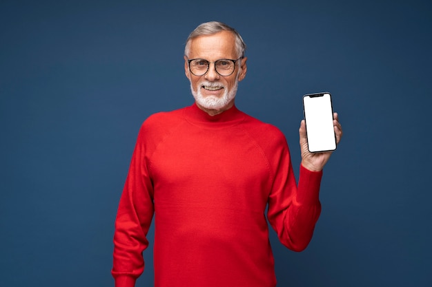 Free photo medium shot smiley man holding device