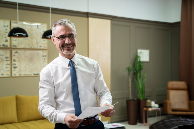 Medium shot smiley man holding document