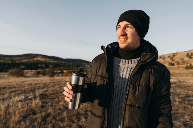 Medium shot smiley man holding flask