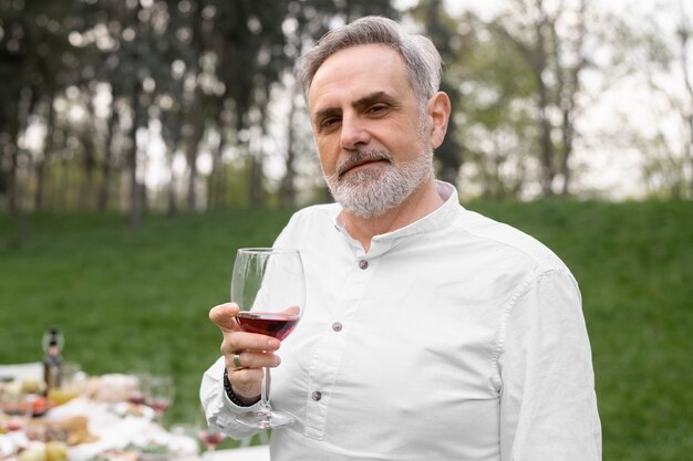 Medium shot smiley man holding glass