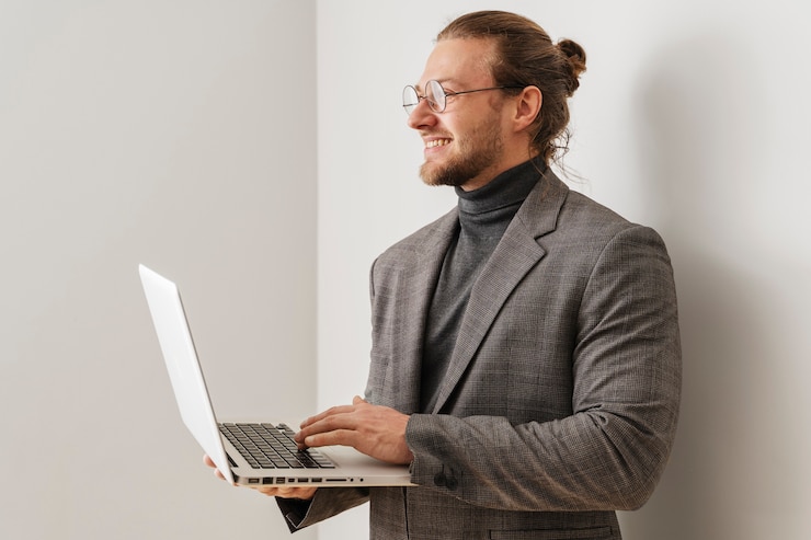 Free Photo medium shot smiley man holding laptop