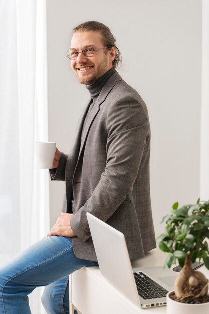 Medium shot smiley man holding mug