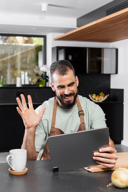 Medium shot smiley man holding tablet