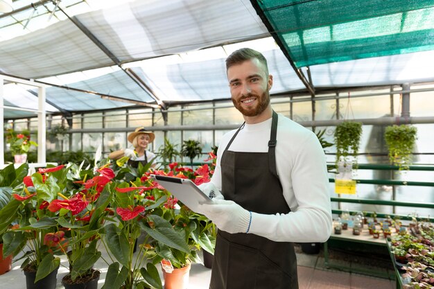 Medium shot smiley man holding tablet