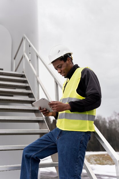 Medium shot smiley man holding tablet