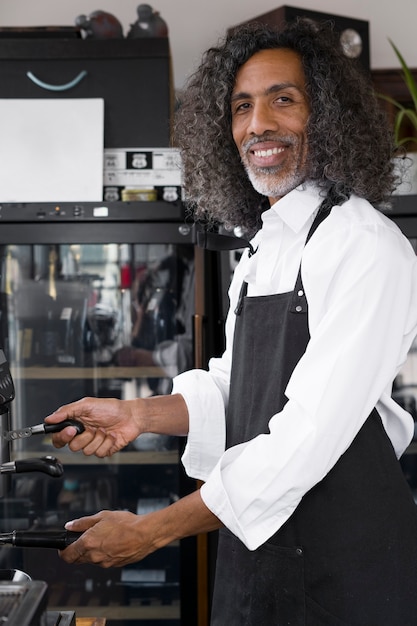 Medium shot smiley man making coffee