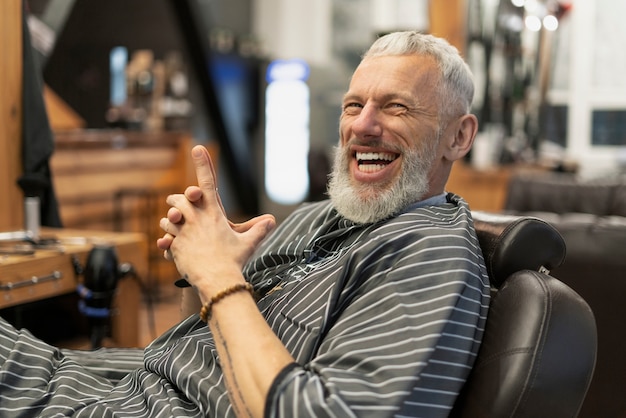 Medium shot smiley man sitting on chair