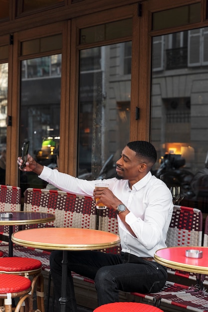 Medium shot smiley man taking selfie