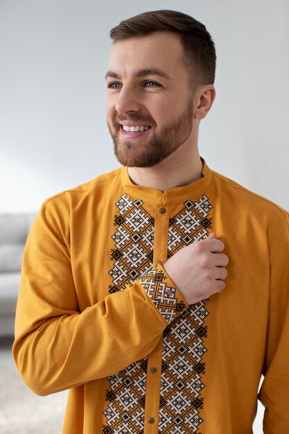 medium shot smiley man wearing ukranian shirt