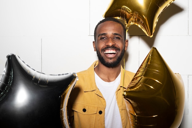 Medium shot smiley man with balloons