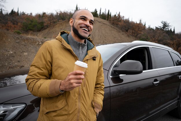 Medium shot smiley man with coffee cup