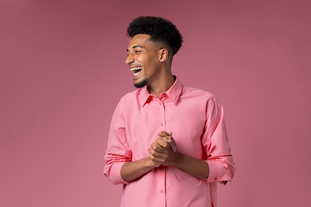 Medium shot smiley man with pink background
