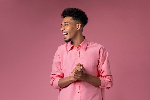 Medium shot smiley man with pink background