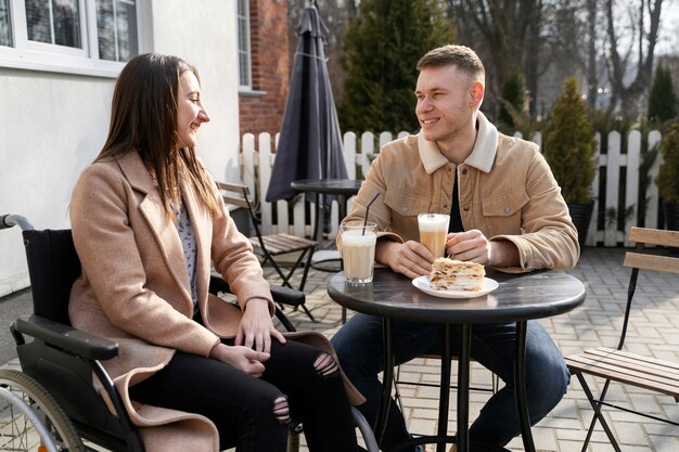 Medium shot smiley man and woman at table