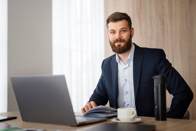 Uomo sorridente a tiro medio al lavoro