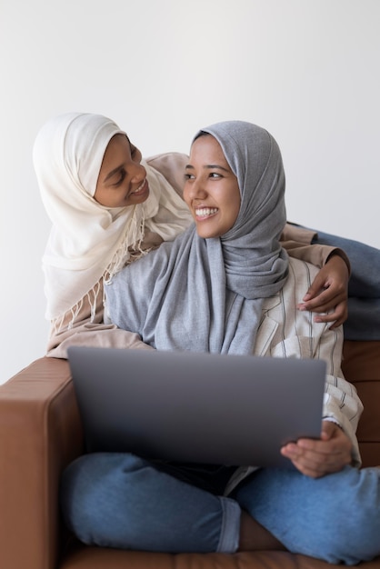 Medium shot smiley muslim women