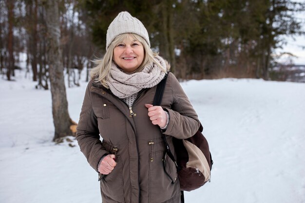 Medium shot smiley old woman in nature