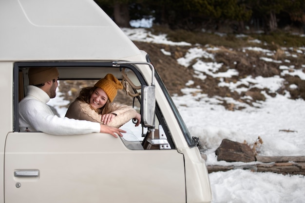 Medium shot smiley people in campervan