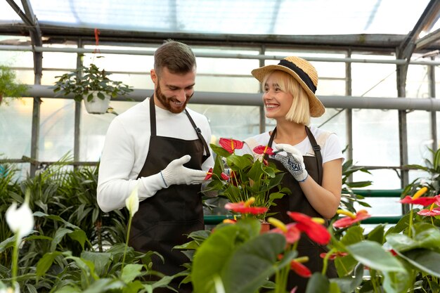 Medium shot smiley people at greenhouse