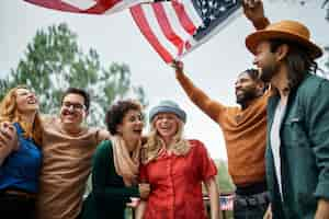 Free photo medium shot smiley people holding flag