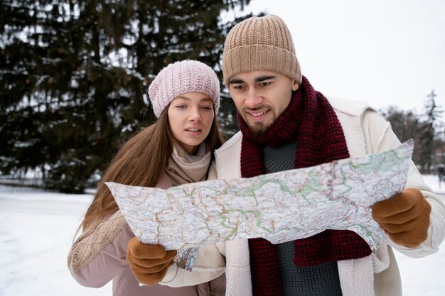 Medium shot smiley people holding map