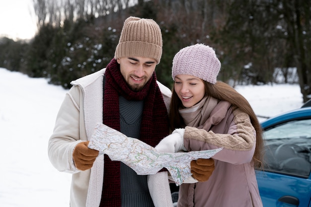 Free photo medium shot smiley people holding map