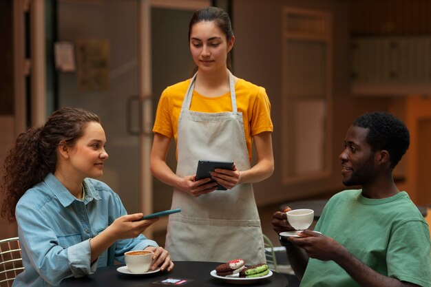 Medium shot smiley people in restaurant