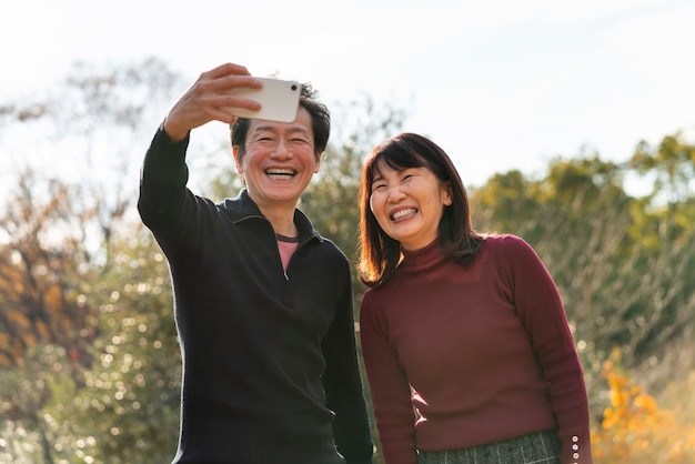 Medium shot smiley people taking selfie