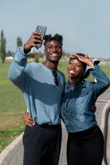 Medium shot smiley people taking selfie