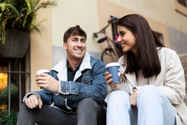 Medium shot smiley people with coffee cups