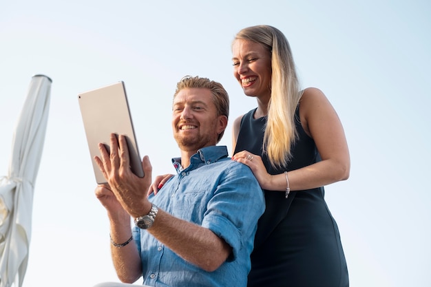 Free photo medium shot smiley people with tablet