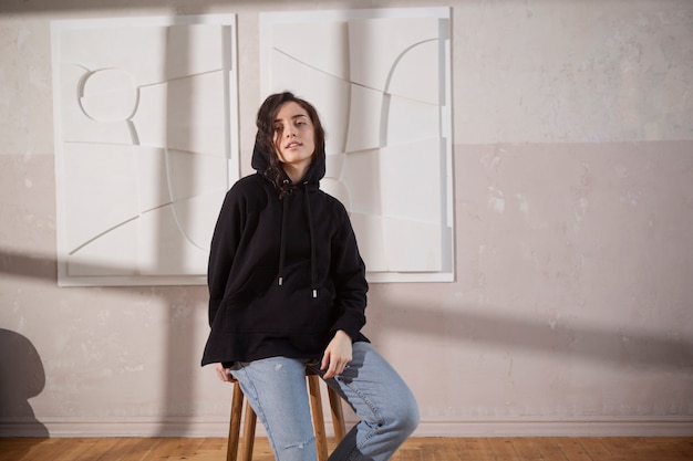 Free photo medium shot smiley posing woman on chair