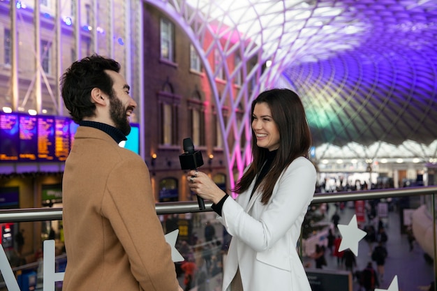 Free photo medium shot smiley reporter outdoors