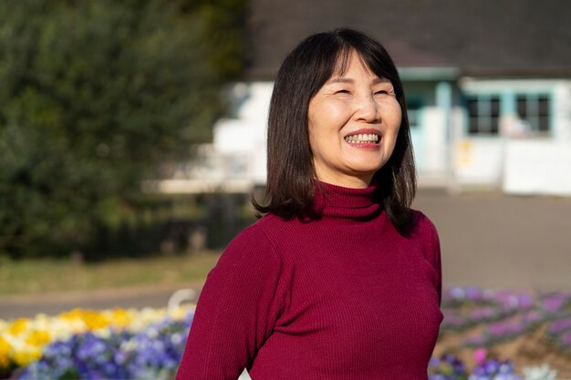 Medium shot smiley retired woman outdoors