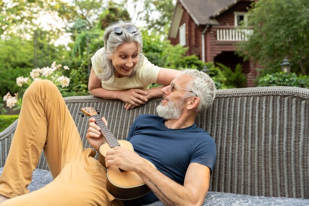 Medium shot smiley senior couple with music