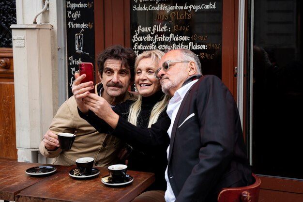 Medium shot smiley senior friends taking selfie