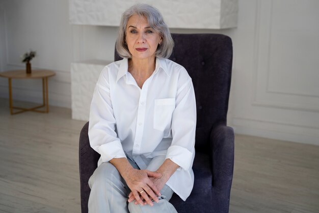 Medium shot smiley senior woman sitting