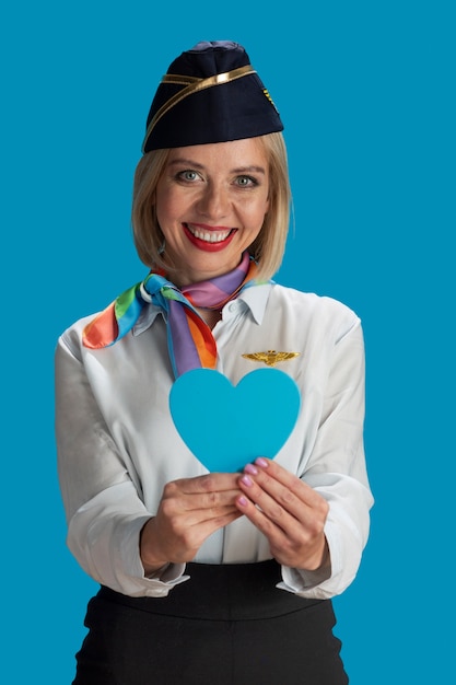 Medium shot smiley stewardess posing