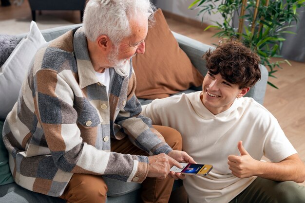 Medium shot smiley teen and grandfather