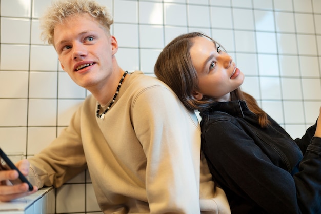 Free photo medium shot smiley teenagers sitting together